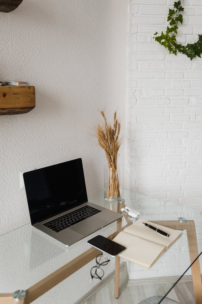 Modern workspace setup with a laptop and smartphone on a minimalist desk.